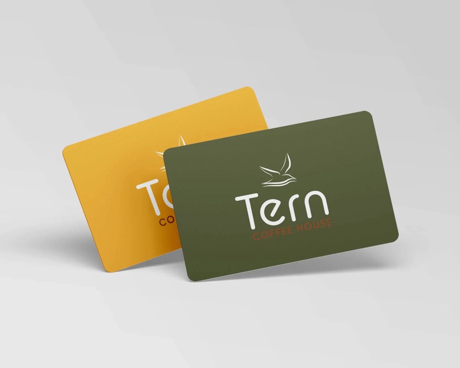 Two Tern gift cards, one olive green and one mustard, with the Tern bird logo